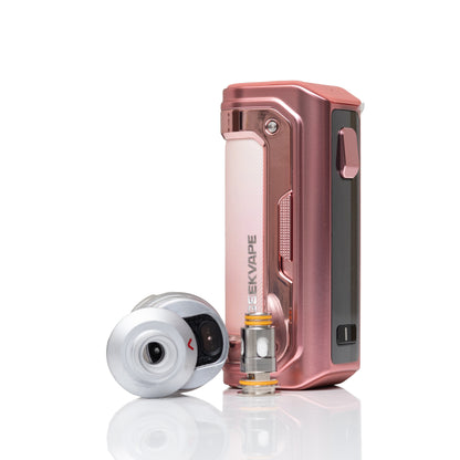 A metallic rose gold KEEKVAPE vape device standing upright next to a silver and black mouthpiece attachment, set against a clean white background with a subtle reflection.