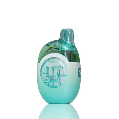 A translucent mint green and white vape device with a clear mouthpiece, standing upright on a reflective white surface.