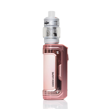 A GEEKVAPE electronic vape device in a metallic rose gold finish, featuring a clear glass tank with silver coils and a white mouthpiece, set against a plain white background with a subtle reflection.
